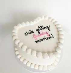 a heart shaped cake with writing on it