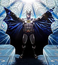 a man dressed as batman standing in front of a stained glass window with his hands on his hips