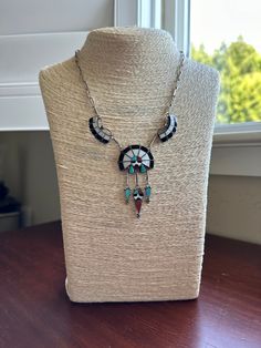 This necklace, crafted of mother of pearl, onyx, coral, and turquoise inlaid into sterling silver, depicts Shumakolowa, the Sun Father, who nourishes all life on Earth. The crisp and precise multi-stone mosaic is beautiful wearable art with spiritual significance.  It was an estate find, clearly worn carefully, as it is in very good vintage condition. The details are perfect, from the sterling silver chain to the delicate panels of gemstone.  Delicate bezels, both channel and crown, carefully cr Black Inlay Jewelry As A Gift, Black Jewelry With Inlay For Gift, Southwestern Jewelry With Inlay For Gifts, Southwestern Style Jewelry With Inlay For Gift, Southwestern Style Inlay Jewelry As Gift, Artisan Sterling Silver Inlay Jewelry, Artisan Sterling Silver Jewelry With Inlay, Sterling Silver Artisan Jewelry With Inlay, Black Sterling Silver Jewelry With Inlay