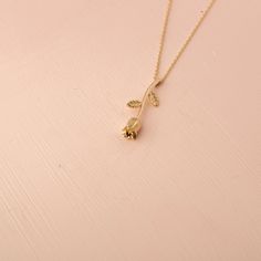 Our 14K Solid Gold Rose Necklace is a testament to timeless beauty and romantic elegance. This exquisite necklace features a rose flower pendant, elegantly crafted and sized at 4.6mm by 24.5mm. Whether you choose the classic appeal of Gold, the gentle allure of Rose Gold, or the modern touch of White Gold, each variant adds a unique charm to the necklace. The skinny cable chain, with a thickness of 0.89 mm, offers an adjustable length of 16" to 18", providing versatility and comfort for various Dainty Rose Colored Necklace For Her, Dainty Rose Necklace As Gift For Her, Feminine Rose Gold Jewelry With Rose Design, Rose Gold Necklaces With Rose Design For Anniversary, Rose Gold Necklace With Flower Pendant, Elegant Gold Necklaces With Rose Details, Elegant Gold Necklaces With Roses, Dainty Rose Gold Necklace With Rose Design, Classic Rose Gold Necklace As Gift For Her