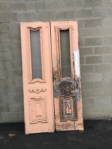 an old pink door sitting next to a brick wall