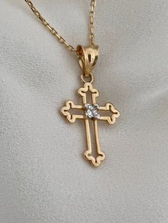 "This is a 14k yellow solid gold (not filled or plated) hollow cross necklace furnished with a tiny shiny cubic zirconia diamond. The necklace is easy to wear alone or layered with something else. This also makes the perfect gift. - 14K SOLID GOLD - WEIGHT: 2.10 gr - Necklace LENGTH: 19 3/4\" - PENDANT LENGTH: 7/8\" Each item comes in a beautiful gift box. HOW TO CARE FOR YOUR JEWELRY: + Unlike any gold-filled, plated, or vermeil jewelry that is not solid gold, wet areas, perfumes, and lotions w Crucifix Necklace With Vvs Clarity As Gift, Gift Crucifix Necklace With Vvs Clarity, Gift Crucifix Necklace Vvs Clarity, Vvs Clarity Crucifix Jewelry Gift, Vvs Clarity Crucifix Necklace As Gift, Classic Cubic Zirconia Cross Necklace For Gift, Classic Cubic Zirconia Cross Necklace As Gift, Diamond Cut Cross Necklace As Gift, Gold Cubic Zirconia Cross Necklace As A Gift