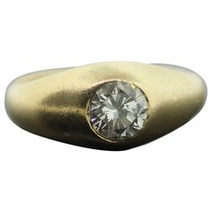 a gold ring with a diamond in the center