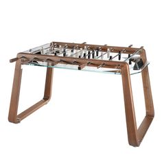 a glass and wood foosball table with soccer balls on it's legs