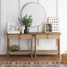 a wooden table topped with a mirror next to a plant