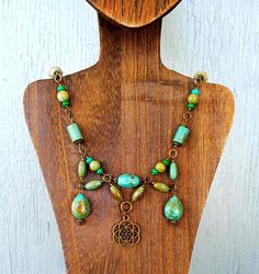 Bronze Indian Magnesite Flower of Life Necklace. 18 in Elegant Handmade Adjustable Turquoise Necklace, Bohemian Green Flower Pendant Jewelry, Green Bohemian Flower Pendant Jewelry, Elegant Turquoise Necklace With Unique Variations, Bohemian Single Strand Dangle Jewelry, Adjustable Flower Pendant Jewelry With Natural Stones, Green Bohemian Single Strand Jewelry, Bohemian Green Single Strand Jewelry, Elegant Handmade Green Flower Necklace