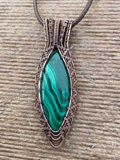 This nicely colored Malachite simple pendant was hand crafted by me with love. Made with 99% copper that has been oxidized to give it a vintage appearance. It features a nicely color patterned, green Malachite. This design is feminine and masculine so would be a great gift for a man or a woman. It is a bigger piece All my pendants come with a simple 20 inch black corded necklace. I can do custom orders on all of the designs in my shop. If you would like a different stone in a particular setting/ Handmade Malachite Healing Necklace, Green Copper Spiritual Necklace, Spiritual Green Copper Necklace, Green Copper Hand Wrapped Necklaces, Green Hand Wrapped Copper Necklace, Antique Copper Necklace For Gift, Adjustable Copper Amulet Jewelry, Green Copper Round Pendant Jewelry, Artisan Green Copper Necklace