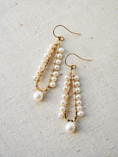 A celebration of pearls in a modern style. A larger pearl dangles from the bottom while smaller pearls line the long teardrop. + Pearls. 14K Gold Filled Ear Wire. 14K Gold Plated Teardrop. + Earrings measure 2.5 inches (6.3 cm) in length. + Earrings take 1 business day to make. + Your jewelry will come in a jewelry box, tied with a ribbon. ➤➤ Have a question about this product, reach out to me here ➙ https://www.etsy.com/conversations/new?with_id=9057464&referring_id=5772224&referring_ty Teardrop Pearl Drop Chandelier Earrings, Teardrop Chandelier Earrings With Pearl Drop, Elegant Teardrop Pearl Earrings With Dangling Beads, Elegant Teardrop Jewelry With Dangling Beads, Pearl Drop Chandelier Earrings, Elegant Pearl Chandelier Earrings With Dangling Beads, Elegant Gold Wire Wrapped Teardrop Earrings, Long Drop Pearl Earrings With Dangling Beads For Wedding, Elegant Teardrop Earrings With Dangling Beads