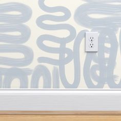 an electrical outlet on the wall in front of a white and blue background with swirls