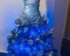 a blue christmas tree with snowflakes on it