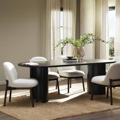 a dining room table with white chairs and a vase filled with flowers on top of it