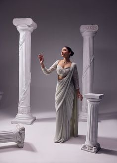 An exquisit Italian imported fabric being the key highlight of this ensemble which is sure to never go out of trend. An artistic symphony of fine aari embroidery adorns the blouse with full sleeves. It has 3D katdana loops, this unreal detailing enhance the ethreal look of the outfit. Colour: Glacier Gray Material: Italian - Saree, Organza- Blouse No of components: 2 Surface Ornamentation: Hand Embroidery Care Instructions: Dry Clean Shipping Time: 3-4 weeks Bollywood Style Formal Blouse With Intricate Embroidery, Bollywood Style Long Sleeve Blouse With Intricate Embroidery, Formal Saree With Resham Embroidery, Designer Long Sleeve Blouse For Wedding, Luxury Long Sleeve Blouse For Wedding, Party Pre-draped Saree With Zari Work And Long Sleeves, Long Sleeve Pre-draped Saree With Zari Work For Party, Designer Fitted Pre-draped Saree With Zari Work, Formal Saree Blouse Piece With Intricate Embroidery