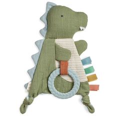 a green stuffed animal with a ring around it's neck and teeth in the shape of a dinosaur