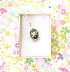 "A gorgeous gold plated photo locket adorned with a lovely vintage black glass limoges with yellow rose dangles so pretty from a 16k gold plated link chain with lobster clasp. Locket has a lovely etched pattern Total length of chain measures 18\" Locket measures 23x30mm Cameo measures 18x13mm Locket is high quality and nickel free Matching bracelet available in my shop as shown in photo 4 (sold out) Your purchase will come beautifully wrapped ready for gift giving" Vintage Gold Jewelry With Birth Flower, Vintage Pressed Flowers Keepsake Jewelry, Vintage Pressed Flowers Jewelry Keepsake, Vintage Gold Jewelry With Birth Flower Detail, Vintage Gold Necklace With Pressed Flowers, Gold Cameo Necklace For Keepsake, Vintage Birth Flower Medallion Jewelry, Vintage Medallion Jewelry With Birth Flower, Vintage Birth Flower Pendant Jewelry