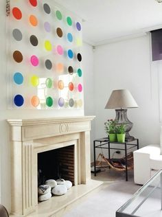 a living room filled with furniture and a fire place covered in multicolored circles