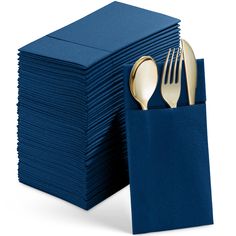 a stack of blue napkins with gold forks and spoons on top of them