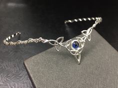 I've fabricated a Celtic Irish wedding bridal circlet, in sterling silver, featuring 5 Trinity Knots with an 8mm round cabochon Of your choice in the drop down menu. This Celtic tiara is lovely, slightly Bohemian and sophisticatedly elegant. This wedding circlet can be used for a wedding accessory, or any costuming event, such as cosplay or a Renaissance fair! Please allow me 5 business days to fabricate a new headpiece for you! **For matching earrings: https://www.etsy.com/listing/42139307/ster Elegant Adjustable Jewelry For Ceremonies, Silver Hallmarked Jewelry For Wedding, Handmade Silver Jewelry For Marriage, Sterling Silver Jewelry For Marriage, Sterling Silver Round Jewelry For Marriage, Adjustable Silver Jewelry With Halo Detail, Traditional Hand Forged Wedding Jewelry, Traditional Hand Forged Jewelry For Wedding, Adjustable Hand Set Silver Necklaces