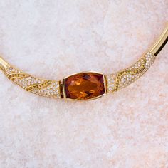 This remarkable necklace is centered with one (1) rectangular cushion cut natural citrine set into a bezel setting. The necklace is also accented with one hundred twenty (120) bead set, round brilliant cut diamonds and thirty- seven (37) channel set, round brilliant cut fancy colored diamonds. The necklace measures 16.8mm wide at the center and tapers to 5.8mm wide along the omega style chain. The necklace measures 17 inches in length and is finished with a box clasp and safety. Rectangular Cushion, Pearl Necklace Designs, Citrine Pendant, Diamond Necklace Set, Bead Set, Box Clasp, Natural Citrine, Channel Set, Fancy Color Diamonds