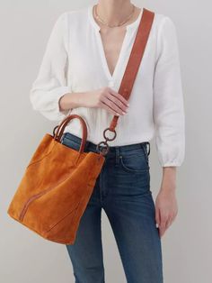 The perfect tote for fall. Leather Bucket Bag For On-the-go Use In Fall, Elegant Cognac Bucket Bag For On-the-go, Fall Rectangular Bucket Bag For On-the-go, Cognac Bucket Bag With Handle Drop, Fall Satchel Bucket Bag With Detachable Handle, Luxury Fall Hobo Bag For Everyday, Modern Rectangular Bucket Bag For Fall, Chic Cognac Satchel With Top Carry Handle, Modern Leather Bucket Bag For Fall