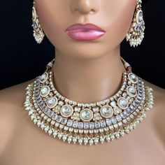 Adorn yourself with timeless elegance with our Bridal White Fine Kundan Gold Plated Necklace Set. Perfect for Indian and Pakistani weddings, this exquisite bridal jewelry features intricate gold-plated designs and sparkling kundan stones. Experience the allure of tradition and make your special day unforgettable. Gold-plated foiled Kundan necklace set. Regular Size And Adjustable Ships from California, USA Delivery in 2-5 business days in the USA. Color, shades, and texture displayed may slightly vary from the actual product due to digital image limitations. We request you consider these minor variations. Please expect the possibility of some slight imperfections when buying handmade jewelry. Please let me know if you have any questions. Arrives in a gift box. Thank you so much for visitin Kundan Bridal Necklace For Diwali Marriage, Bollywood Kundan Bridal Accessories For Marriage, Kundan Bridal Necklace For Marriage During Diwali, Kundan Bridal Necklace With Tilla For Wedding, Kundan Bridal Necklace With Tilla For Marriage, Kundan Bridal Necklace In Temple Jewelry Style For Marriage, Silver Kundan Necklace For Marriage In Temple Jewelry Style, Bollywood Kundan Necklace For Marriage With Intricate Design, Silver Meenakari Jewelry For Marriage