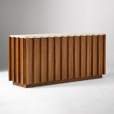 a wooden cabinet sitting on top of a white floor