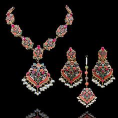 Nauratan timelessness that carry distinct style, intricacy and craftsmanship of a bygone era! Adorn charisma with this talismanic set studded with ethereal stones and the grace of pearl moti along with the radiance of traditional and aesthetic identity. The set includes a necklace, a maang teekah and a pair of stunning earrings. Approximate earrings length is 3.5". Gold-plated on high-quality brass as base metal. Made by order. Kindly allow 5-7 weeks for the delivery of this item. For custom or Fusion Style Kundan Necklace With Gemstones For Ceremonies, Multicolor Gemstone Jewelry For Ceremonial Occasions, Multicolor Gemstone Jewelry For Ceremonial Use, Heavy Multicolor Jewelry For Ceremonial Occasions, Fusion Style Multicolor Jewelry With Intricate Design, Bohemian Gold Sets For Eid, Elegant Meenakari Sets For Ceremonial Occasions, Traditional Sets With Intricate Design For Festive Occasions, Bold Multicolor Ceremonial Jewelry