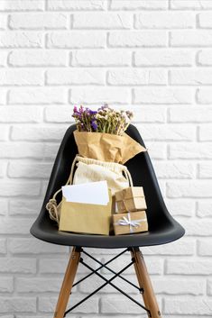 a chair that has some bags on it and flowers in the bag next to it