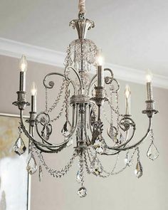 a chandelier hanging from the ceiling in a room