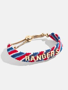 Proudly show off your team loyalty with the Texas Rangers MLB Woven Friendship bracelet. This bracelet is crafted with colorful woven thread, which creates a vibrant backdrop for your favorite game day rallying cheer. Secured with an easy pull-tie closure, this spirited and nostalgic accessory will be loved by fellow fans all season long. Please note: due to their handmade nature, each bracelet will be slightly unique. This is an officially licensed MLB product. Team-colored Wristband For Game Day, Casual Adjustable Wristband For Fan Merchandise, Adjustable Team Spirit Friendship Bracelets For Game Day, Casual Adjustable Wristband For Game Day, Casual Multicolor Bracelets For Game Day, Team Bracelets, Ny Rangers, Rallying, Texas Rangers