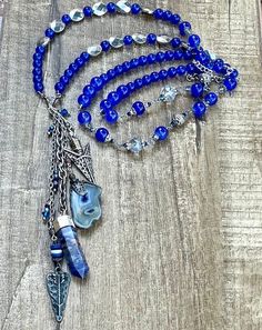 This is a beautiful one of a kind beaded blue stone and crystal charm necklace. Semi precious Stones. Crystal charm. This necklace is made 36 inches long and has an adjustable silver chain. Beaded charm necklace.  Necklaces can be made any size, color or style. Please send me a message if you would like a certain size, color, or style made especially for you!  Thank you for visiting and shopping 27inHeaven! ❤️ Michelle Hoeft Handmade Bohemian Sapphire Necklace, Blue Beaded Crystal Necklace, Blue Beaded Necklaces With Stones For Jewelry Making, Blue Gemstone Beads Necklace In Mineral Crystal, Blue Crystal Beaded Necklaces For Jewelry Making, Blue Crystal Jewelry With Gemstone Beads, Handmade Blue Mineral Crystal Necklace, Unique Blue Mineral Crystal Necklace, Bohemian Crystal Pendant Necklaces