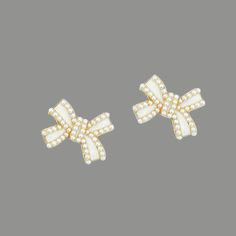 Petite bow shaped post earrings with ivory pearl detail. 14k Gold plated. Hypoallergenic. Measures at approximately 1 inch diameter. White Bow Earrings For Anniversary, White Bow Jewelry For Formal Occasions, White Formal Jewelry With Bow Detail, Formal White Jewelry With Bow Detail, Formal White Bow Jewelry, White Bow Jewelry For Anniversary, Ivory Pearl, Bow Earrings, Post Earrings