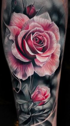 a woman's leg with a rose tattoo on it