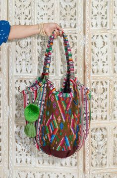 Colorful bohemian tote bag crafted from Guatemalan textiles Bohemian Fair Trade Bucket Bag For Daily Use, Fair Trade Bucket Bag For Everyday Use, Fair Trade Everyday Bucket Bag, Bohemian Multicolor Bucket Bag For Beach, Bohemian Multicolor Bucket Bag For Travel, Bohemian Woven Bucket Tote Bag, Artisan Bucket Tote Bag For Festivals, Bohemian Crochet Bucket Bag With Leather Handles, Multicolor Bohemian Bucket Hobo Bag