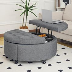 a grey ottoman with a laptop on it