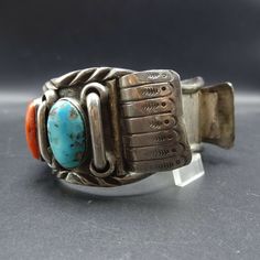 "VINTAGE WATCH CUFF BRACELET DESCRIPTION: This fabulous cuff features beautiful old specimens of turquoise and red Mediterranean coral, on a foundation of heavy gauge, hand-wrought sterling silver. This watch cuff bracelet will be a cherished addition to your collection of fine vintage Native American jewelry. MEASUREMENTS: Interior of the cuff measures 6\" with an additional 1 1/8\" non-adjustable gap. Total circumference: 7 1/8\" Measures 2 9/16\" straight across the widest part of the cuff (f Vintage Adjustable Cuff Watch, Vintage Cuff Watch Band As Gift, Vintage Cuff Watch, Vintage Turquoise Bangle Cuff Bracelet, Adjustable Vintage Turquoise Cuff Bracelet, Adjustable Turquoise Vintage Cuff Bracelet, Vintage Cuff Bracelet Watch Bands, Vintage Cuff Watch Bands With Bracelet Strap, Red Adjustable Vintage Cuff Bracelet