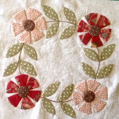 a close up of a piece of cloth with flowers on it and leaves in the middle