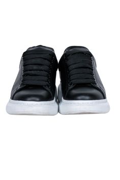 Elevate your fashion with Alexander McQueen's awesome black leather lace up sneakers. Great for a Sunday brunch with the squad, or a laid-back evening out, pair these kicks with your go-to denim and tee, or rock a playful frock. Size 6.5 (IT 36.5) Made in Italy Leather upper and lining Rubber sole Lace-up front Toe to heel 10.5" Back platform 1.75" Black Lace-up Platform Sneakers For Streetwear, Black High-top Sneakers With Laces, Custom Leather High-top Sneakers With Elastic Laces, Custom High-top Leather Sneakers With Elastic Laces, Streetwear Sneakers With Elastic Laces And Round Toe, Black Lace-up Sneakers With Rubber Sole, Leather Low-top Lace-up Shoes With Elastic Laces, Black Low-top Sneakers With Laces, Leather Sneakers With Elastic Laces