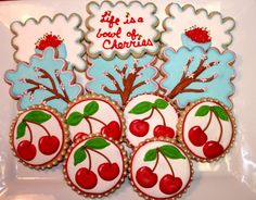 cookies decorated with cherries on a plate