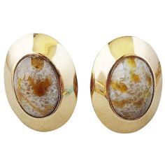 1960s goldtone cabochon faux-agate paste clip back earrings. Unmarked but came with the matching bracelet which was signed. Stones have flecks in them that sparkle. Condition: Very Good; light goldtone wear to front, some light wear to backs. Measure: 1.5 inches L x 1.13 inches W. Gold Clip-on Earrings With Gemstone, Gold Vintage Cabochons, Vintage Gold Gemstone Earrings, Gold Gemstone Clip-on Earrings For Anniversary, Formal Gold Clip-on Cabochons, Gold Gemstone Clip-on Earrings For Formal Occasions, Formal Gold Gemstone Clip-on Earrings, Retro Gold Oval Earrings, Vintage Oval Gold Cabochons