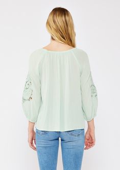 A casual bohemian blouse with a beautiful paisley lace detail on sleeve. Relaxed, flowy fit Elastic on or off-shoulder neckline 3/4 length sleeves Elastic wrist cuff Lace detail Flowy bohemian blouse Dry clean recommended or hand wash cold Step into effortless bohemian chic with this versatile blouse, beautifully designed with intricate paisley lace detailing. The relaxed fit effortlessly flatters any figure, while the elastic round neckline offers different styling options. Wear it as-is for a Spring Off-shoulder Top With Blouson Sleeves, Spring Bohemian Half-sleeve Blouse, Spring Bohemian Half Sleeve Blouse, Bohemian Half Sleeve Blouse For Spring, Bohemian Spring Tops With 3/4 Sleeves, Summer Long Sleeve Off-shoulder Top With Blouson Sleeves, Summer Off-shoulder Top With Blouson Sleeves, Bohemian Tops With Lace Sleeves For Fall, Spring Half Sleeve Tops With Lace Trim