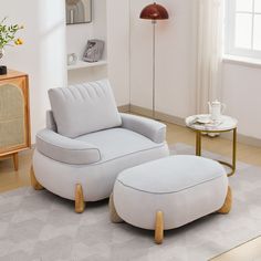 a white chair and ottoman in a living room