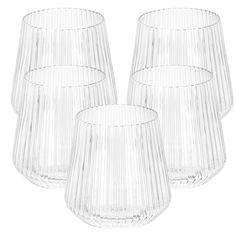 four clear glass vases sitting next to each other