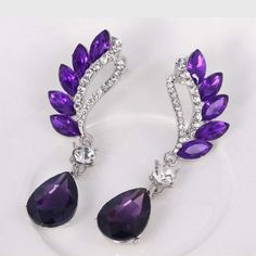 Vintage Flight Purple Gem Statement Earrings – Wicked Wonders Fairy Tale Jewelry, Cocktail Earrings, Purple Gems, Trendy Fashion Jewelry, Purple Earrings, Long Dangle Earrings, Wing Earrings, White Rhinestone, Crystal Stud Earrings