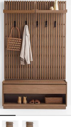 a wooden bench with two baskets on it and some towels hanging from the back wall