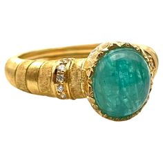 The Paraiba Tourmaline is the rarest gemstone in the jewelry world today. It is a copper-bearing tourmaline with the element turning it a wonderful shade of tropical blue. This fantastic ring was handmade by a family jeweler outside of Florence, Italy. The cabochon-cut tourmaline was hand-selected for this piece making it one-of-a-kind. It features scalloped detailing along the bezel and rich, silk lines carved individually into the shank. Set in solid, 18-karat yellow gold is one Paraiba Tourma Paraiba Tourmaline, Tropical Blue, Rare Gemstones, Florence Italy, Cocktail Rings, Florence, Tourmaline, Diamond Cuts, Diamond Ring