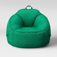 a green bean bag chair sitting on top of a white floor