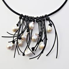 Leather & Pearl Necklace - Large cultured, fresh water, baroque pearls are hand knotted with leather on a heavy leather cord. The leather fringe falls six inches at its longest point. <br><br>Finished with a magnetic clasp. Bohemian Handmade Baroque Pearl Necklaces, Handmade Bohemian Baroque Pearl Necklace, Baroque Pearl Lariat Necklace With Pendant, Black Baroque Pearl Necklace, Black Pearl Leather Necklace, Pearl Fringe, Leather Statement Necklace, Leather Pearl Necklace, Fiber Necklace