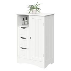 a white cabinet with two drawers and a potted plant on top