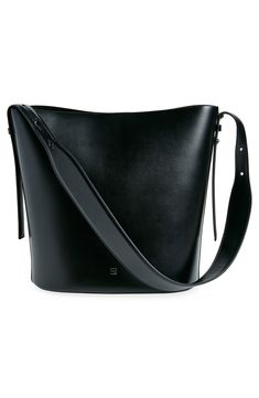 A clean-lined minimalist design defines this spacious bucket bag crafted of smooth calfskin leather. The adjustable strap is wider in the middle for a comfortable carry, either in hand or over the shoulder. Magnetic snap closure Adjustable shoulder strap Structured silhouette with flat base for stability Leather Made in Italy Designer Handbags Black Owned/Founded Elegant Black Bucket Bag With Smooth Grain, Modern Bucket Bag With Adjustable Strap For Evening, Smooth Grain Bucket Shoulder Bag For Work, Smooth Grain Calf Leather Bucket Bag, Modern Smooth Grain Bucket Bag For Everyday Use, Chic Rectangular Calf Leather Bucket Bag, Modern Evening Bucket Hobo Bag, Classic Smooth Grain Bucket Hobo Bag, Smooth Grain Bucket Shoulder Bag For Shopping