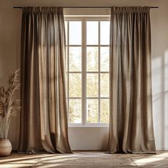 an open window with curtains and a potted plant on the floor next to it